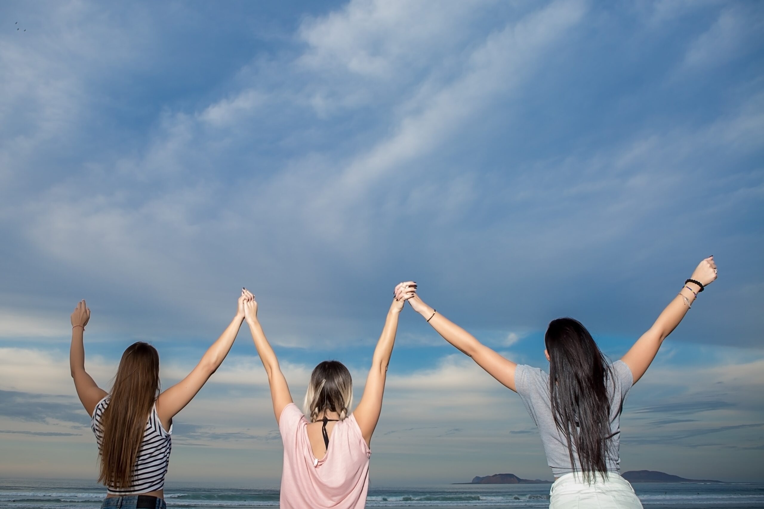 happy friends holding hands up 2023 11 27 05 07 13 utc min scaled 1