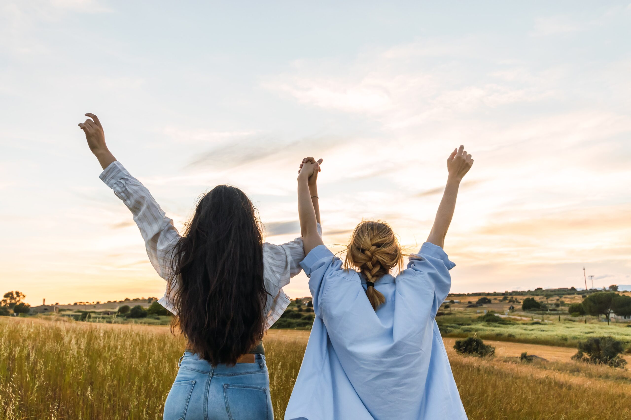 two young women enjoying nature with the hands up 2024 02 08 19 42 10 utc min scaled 2