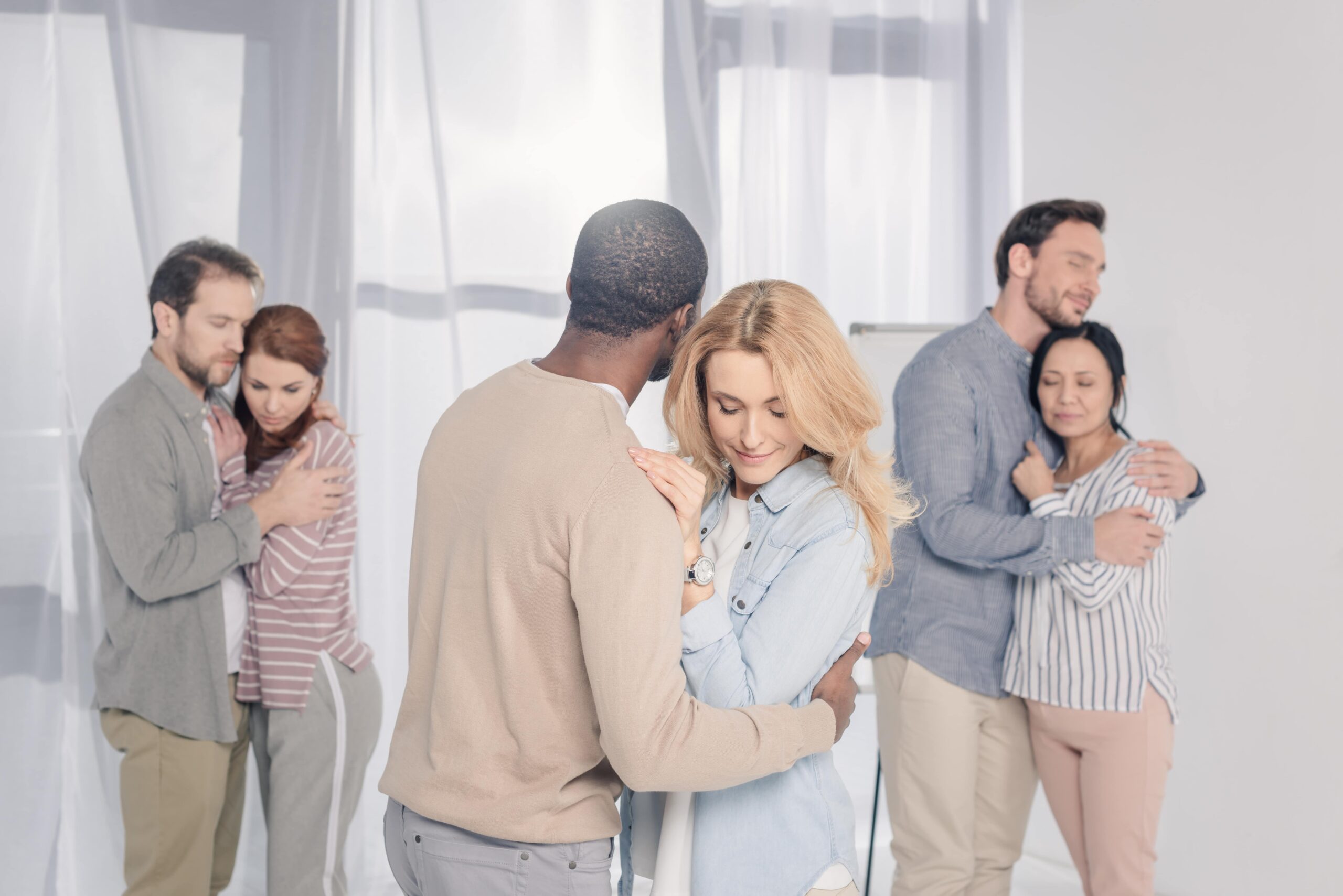 three multiethnic couples hugging during psychothe 2024 11 19 13 31 56 utc min scaled 2